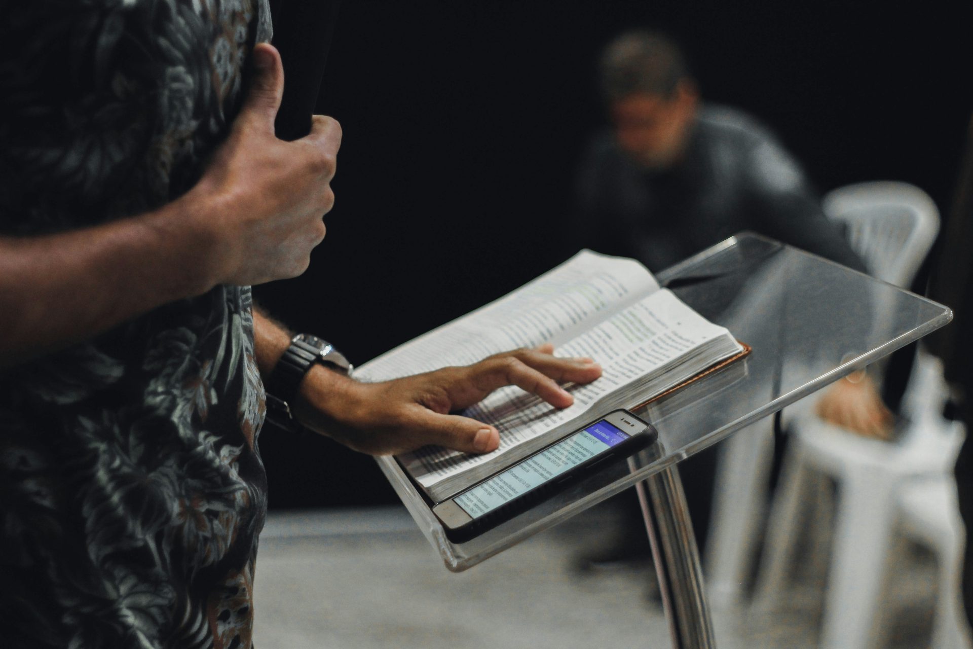 Hand holding book and phone