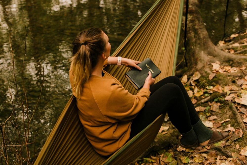 Person reading in hammock
